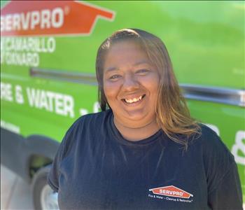 Portrait of Amanda, female employee in front of green truck