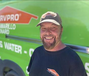 Portrait of male employee Jaison, in front of green truck